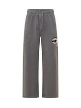 KIDSUPER - Wide leg sweatpants featuring a straight silhouette and an elasticated waistband with adjustable drawstring. Detailed with a stylized eye applique on the upper leg and straight hems. - Grey - LIDIASHOPPING® - Official Website
